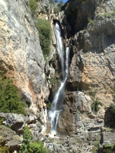 a waterfall on the side of a rocky mountain at Casas Rurales Tiscar in Arroyo Frio