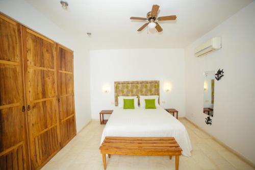 a bedroom with a bed and a ceiling fan at Bioma Boutique Hotel in Mompos