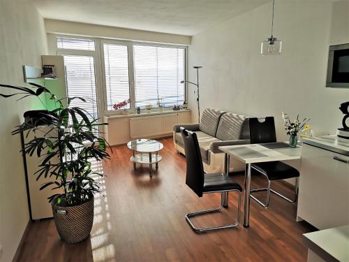 a living room with a couch and a table at New apartment with garage parking in Brno