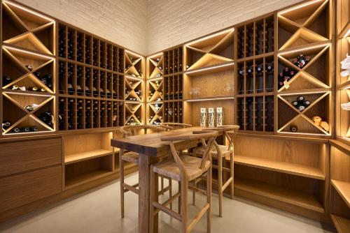 a wine cellar with a wooden table and wooden wine racks at Glen Harry Game Reserve in Graaff-Reinet