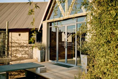 a glass door of a building with a table in front at Glen Harry Game Reserve in Graaff-Reinet