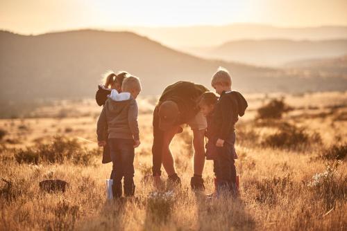 a group of three children standing in a field at Glen Harry Game Reserve in Graaff-Reinet