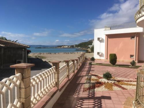 a white picket fence next to a beach at Sea Paradise Apartment Complex in Kavarna