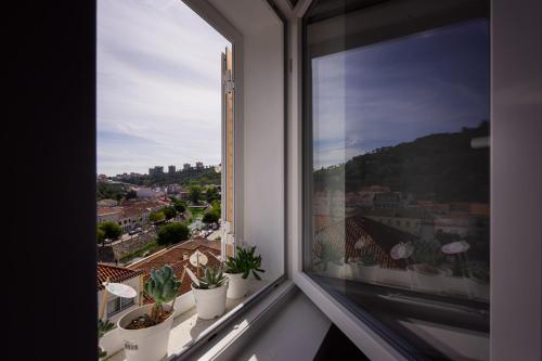 a window with a view of a city at Casinha da Encosta in Alenquer