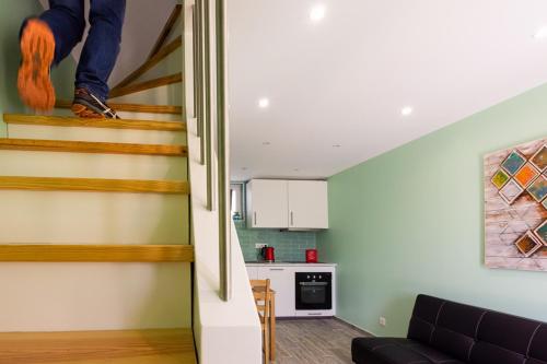 a living room with a staircase leading to a kitchen at Casinha da Encosta in Alenquer