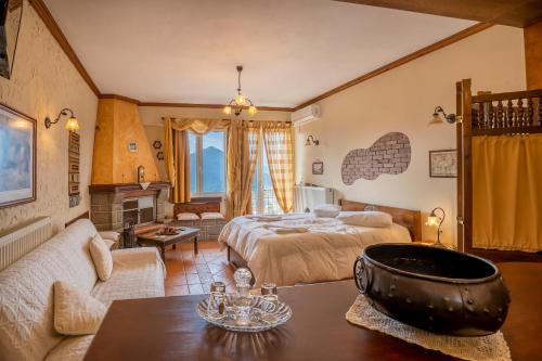 a bedroom with a bed and a living room at Semeli Guesthouse in Karpenision