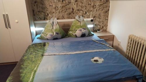 a bedroom with a bed with two soccer balls on it at Apartmany Železná Ruda in Železná Ruda