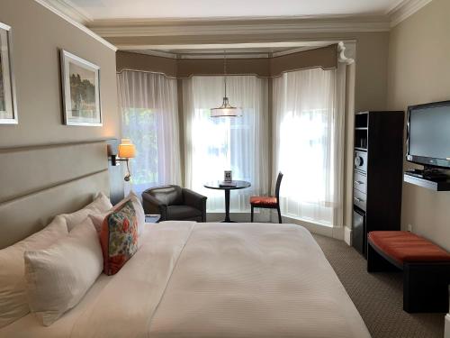 a hotel room with a bed and a television at Newbury Guest House in Boston