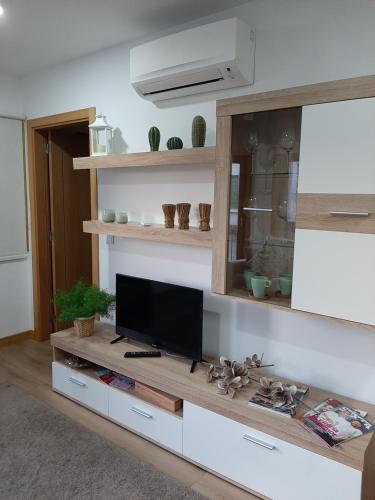 a living room with a flat screen tv on a table at Casa da Ponte in Mirandela