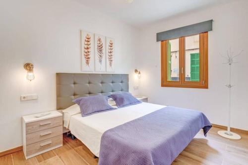 a bedroom with a large bed and a window at Son Trast in Vilafranca de Bonany