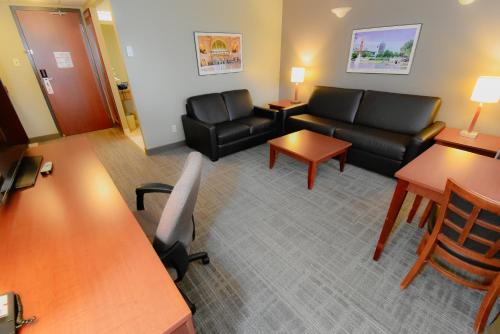 a living room with a couch and chairs and tables at Canad Inns Destination Centre Fort Garry in Winnipeg