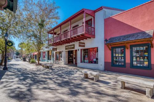 a street with benches in front of buildings at 110 St. George Street in St. Augustine