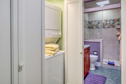 a bathroom with a toilet and a sink and a shower at St. George Street Apartment in Saint Augustine