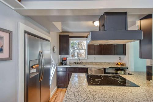 a kitchen with a stainless steel refrigerator and wooden cabinets at 1 Fletcher Ln in St. Augustine