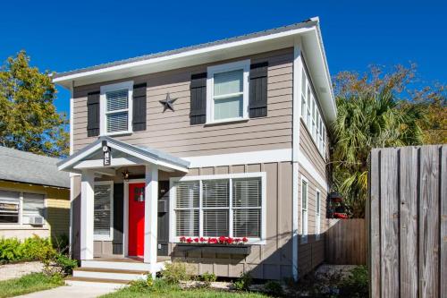 a house with a red door and a fence at 1 Fletcher Ln in St. Augustine