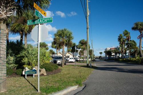 a street sign for al seaford street with palm trees at 102 10th St. in Saint Augustine Beach