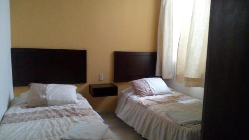 Llit o llits en una habitació de Hotel Posada San Juan