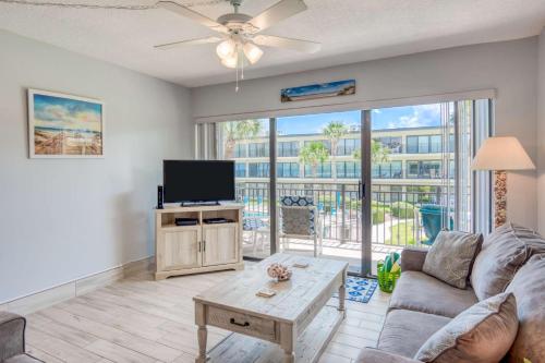 a living room with a couch and a flat screen tv at Grandma's Rest East in Saint Augustine