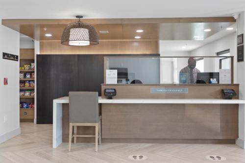 a man is standing at a counter in a store at Staybridge Suites - Atlanta NE - Duluth by IHG in Duluth