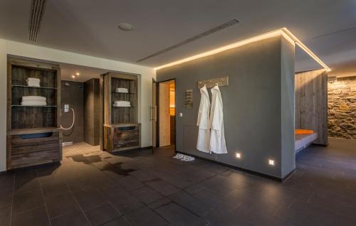 a room with a dress hanging on a wall at Das Graseck - mountain hideaway & health care in Garmisch-Partenkirchen