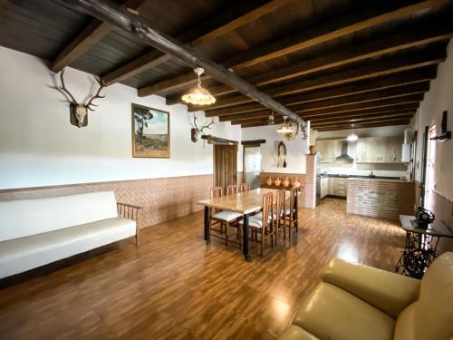 a kitchen and dining room with a table and chairs at CASA CUEVA PIENA, Alcudia de Guadix in Alcudia de Guadix