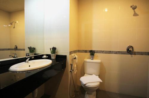 a bathroom with a toilet and a sink at Aroma Hotel in Butterworth