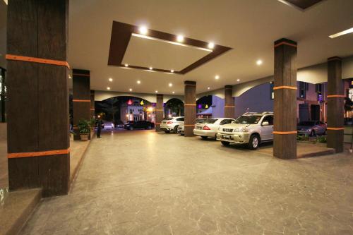 a parking lot with cars parked in a building at Aroma Hotel in Butterworth