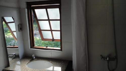 a bathroom with a sink and a window at El Quincho in San Luis