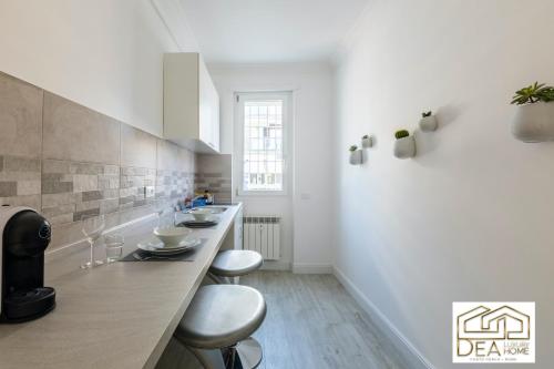 a kitchen with two sinks and two stools at Ponte Milvio Suite in Rome