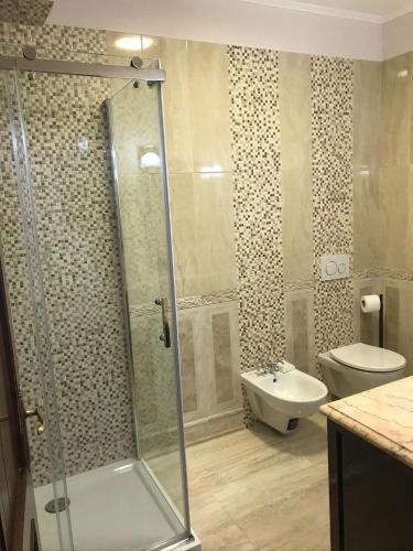 a bathroom with a shower and a sink and a toilet at VECCHIA FAVOLA HOUSE in Quarto dʼAltino