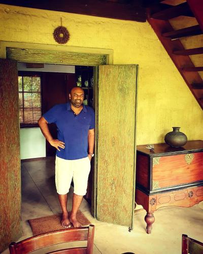 a man standing in the doorway of a house at Dunes Unawatuna Hotel in Unawatuna