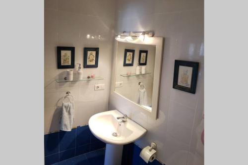 a bathroom with a sink and a mirror at Apartamento Las Infantas. Centro de Sanlucar. in Sanlúcar de Barrameda