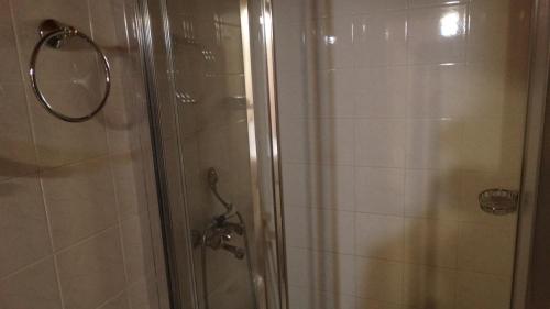 a bathroom with a shower with a glass door at Akrotainaritis Rooms in Gerolimenas