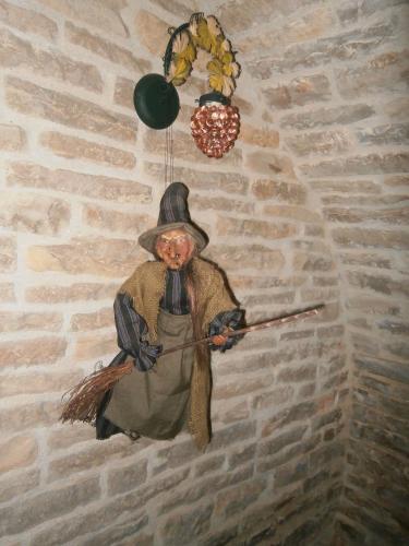 a wall mounted statue of a man holding a spear at Logis Saint Martin in Magny-lès-Villers