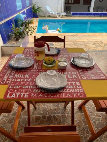 a picnic table with plates of food on it at Pousada Recanto do Mar in Saquarema