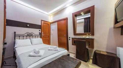 a bedroom with a bed with a mirror and a desk at NOHO Boutique Koukaki , premium living in Athens