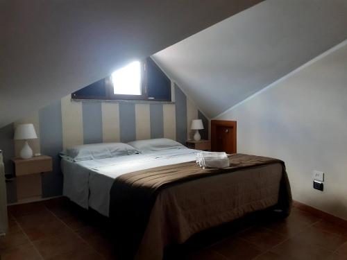 a bedroom with a large bed with a window at B&B BABY D in Montalto Uffugo