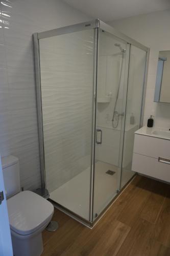 a bathroom with a shower with a toilet and a sink at Casa Soleada in La Oliva