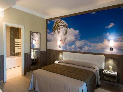 a bedroom with a large painting on the wall at Eracle Hotel in Volla