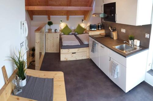 a small kitchen with a couch in a tiny house at Appartment in the Sky in Bílovice nad Svitavou