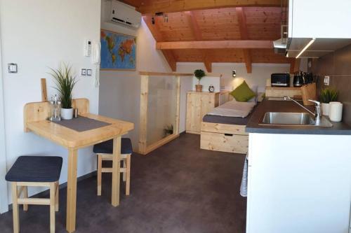 a small kitchen with a sink and a table at Appartment in the Sky in Bílovice nad Svitavou