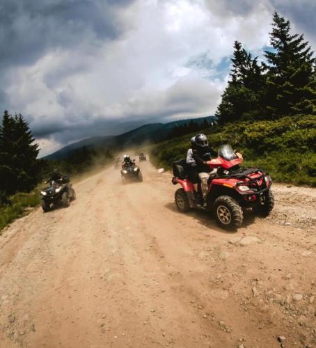 a group of people riding on atvs on a dirt road at Apartments Suncani Vrhovi Kopaonik in Kopaonik