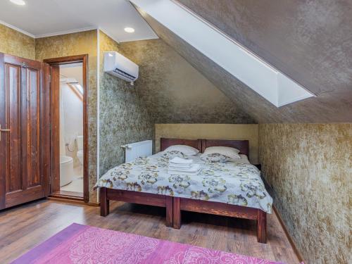 a bedroom with a bed and a skylight at Casa Saraste in Râşnov