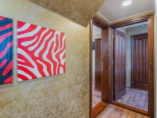 a hallway with two paintings on the wall at Casa Saraste in Râşnov