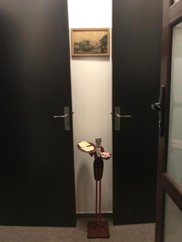 a room with two doors and a statue in the middle at Casa IDA 1896 in Galaţi
