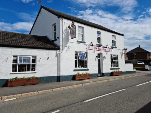 a white building on the side of a street at The Red Lion in Kilsby