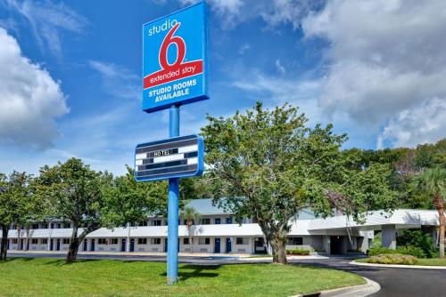 a sign for a gas station in front of a building at Studio 6-Jacksonville, FL - Baymeadows in Jacksonville