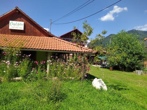a house in a field with flowers in front of it at Casa Matteo in Arefu