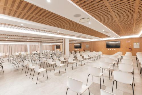 a conference room with white chairs and a lectern at The Ibiza Twiins - 4* Sup in Playa d'en Bossa