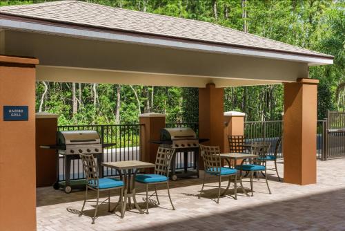 a pavilion with tables and chairs on a patio at Candlewood Suites - Orlando - Lake Buena Vista by IHG in Orlando